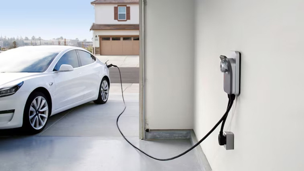 An electric vehical is charging, with the text, Clean BC, our nature, our value, our future. Clean BC Go Electric, EV charging Rebate Program.