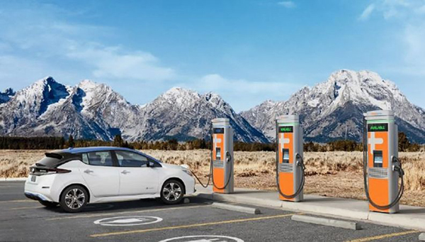 An electric vehical is charging, with the text, Clean BC, our nature, our value, our future. Clean BC Go Electric, EV charging Rebate Program.